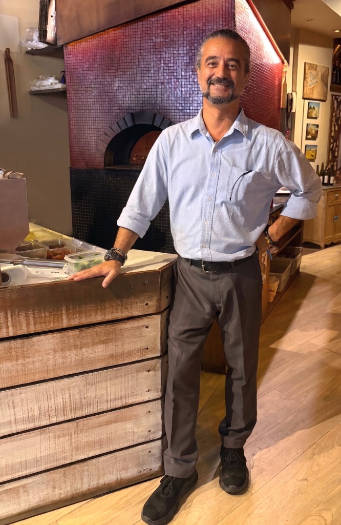 Restaurant Manager Giovanni in front of the wood-fired pizza oven at Gusto Italiano, Koh Samui